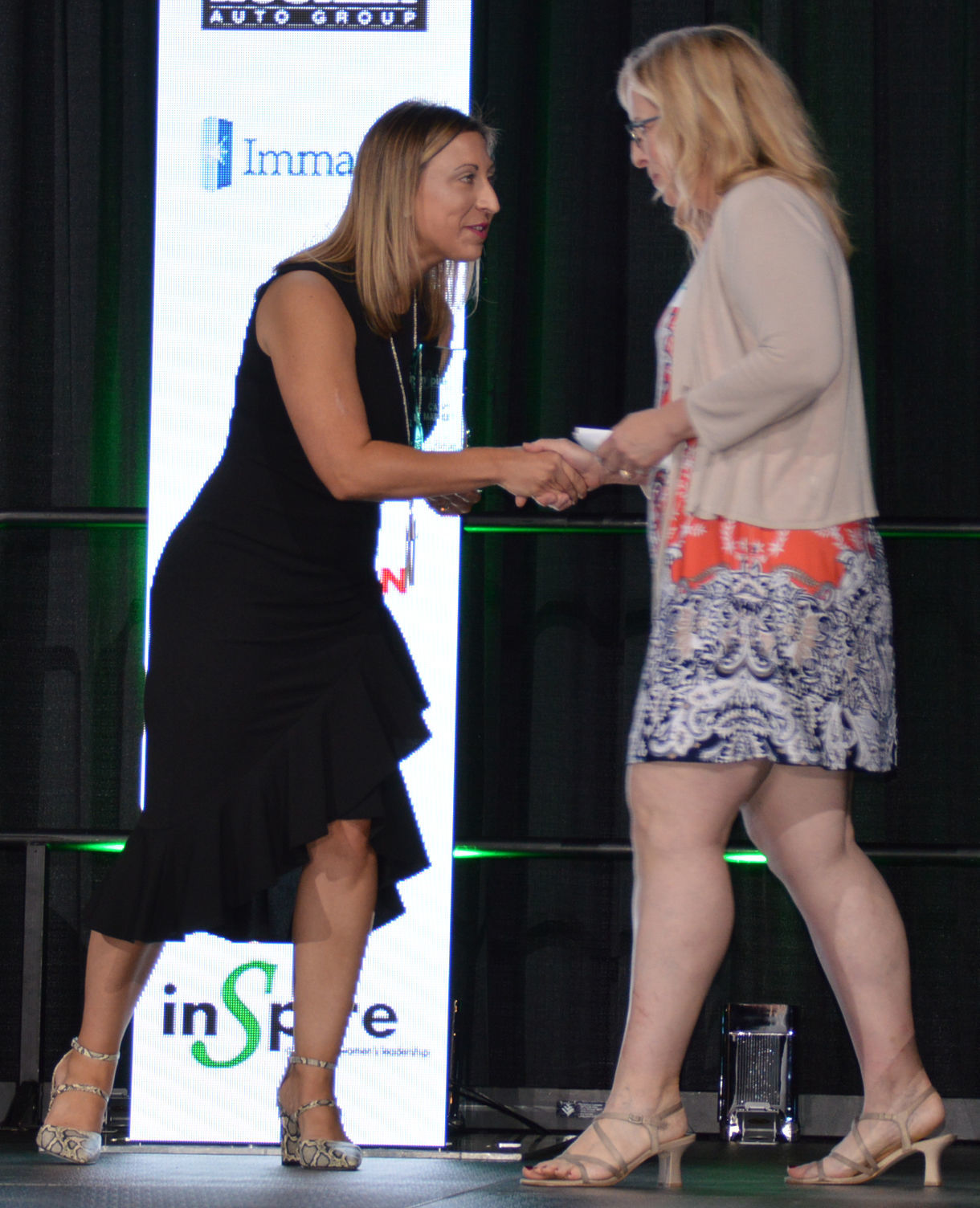 Natalie Wiita congratulates Cathy Martinez of Autism Family Network on Excellence in Nonprofit award.JPG